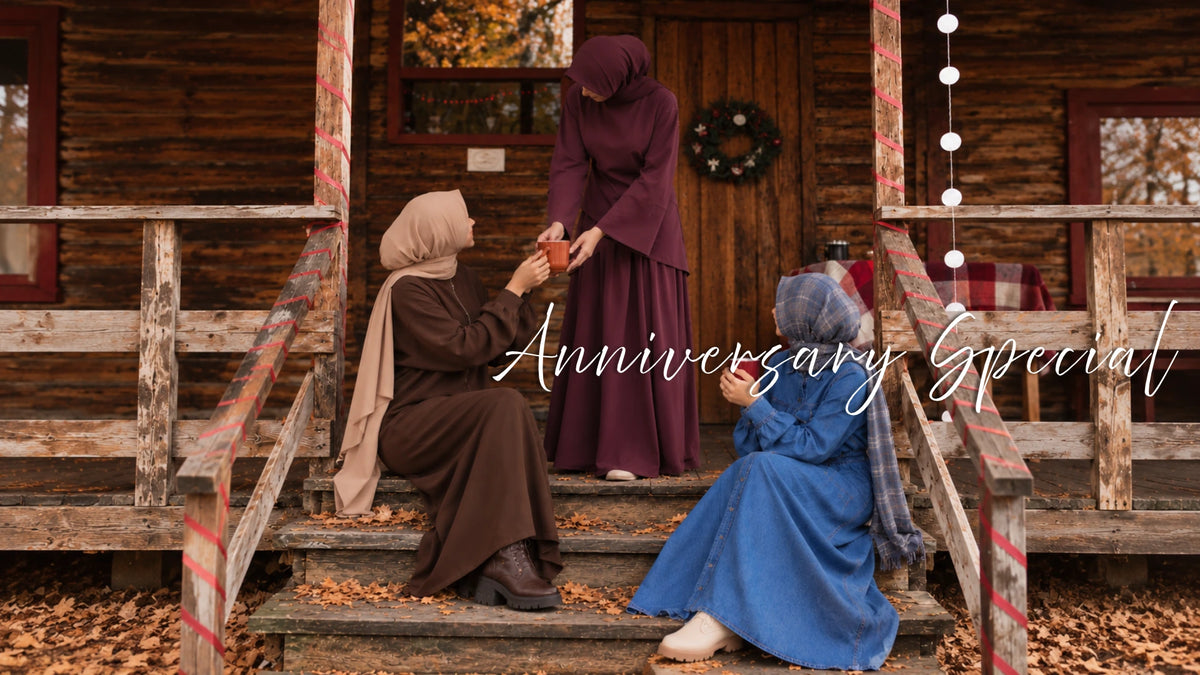 Three hijabi models wearing modest maxi dresses from Try Modest, featuring blue denim abayas and a brown co-ord set in a cozy autumn setting for Anniversary Special Week.