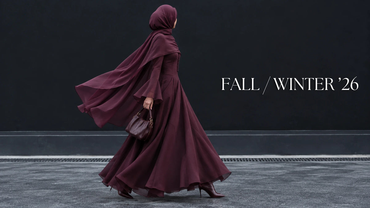 Try Modest Belle burgundy wedding guest maxi dress with elegant flare cuffs and flowing cape, styled with a matching hijab for modest fall occasion wear.